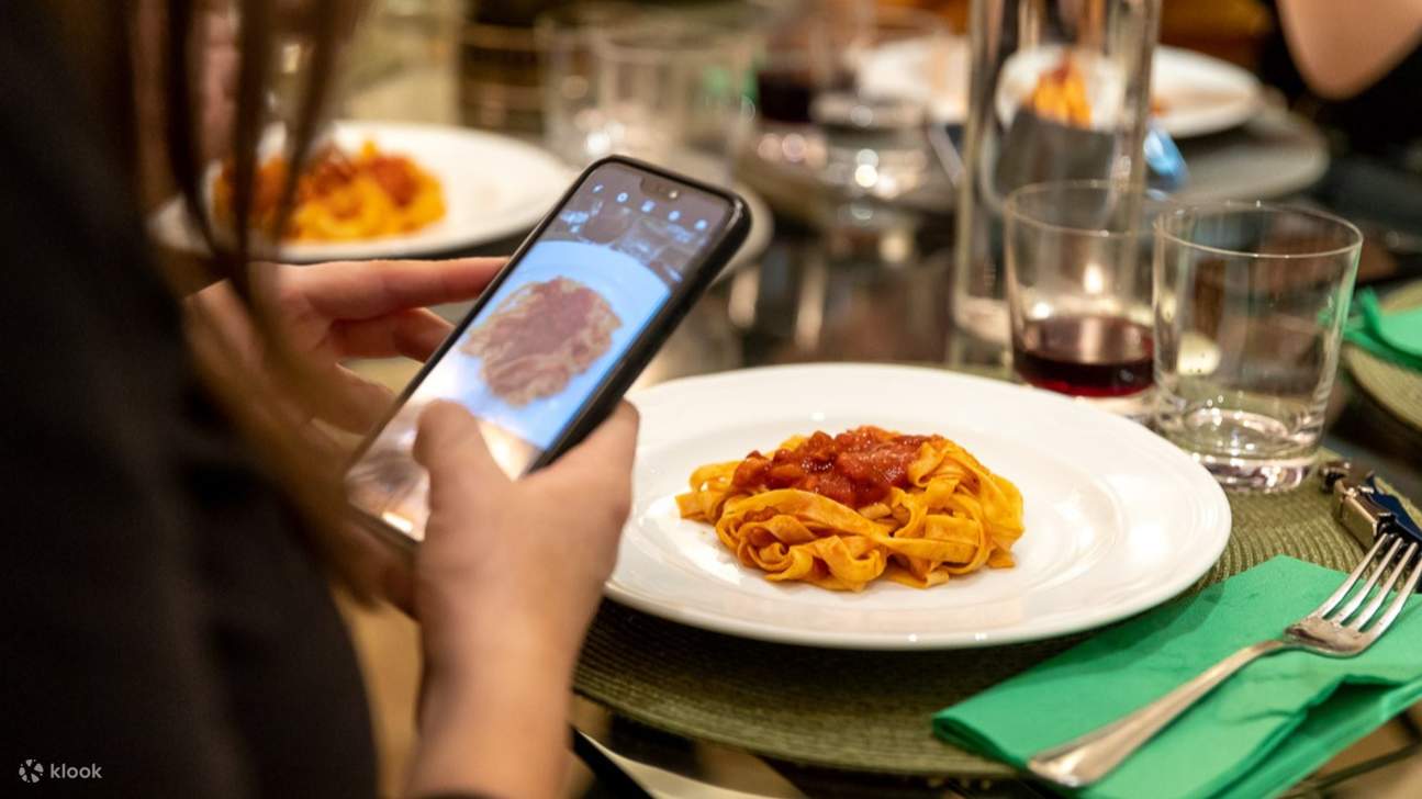 Capturing the perfect shot before indulging in a plate of homemade Italian tagliatelle