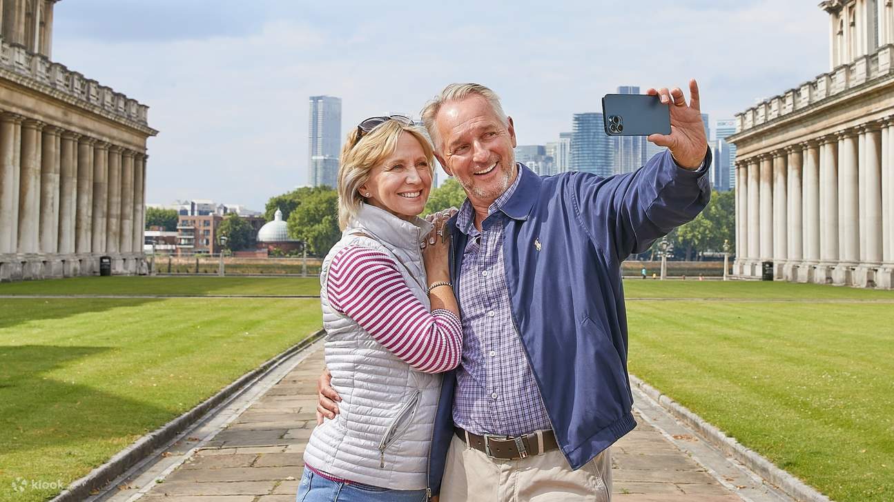 Una coppia felice posa per un selfie con l'iconico Old Royal Naval College di Londra