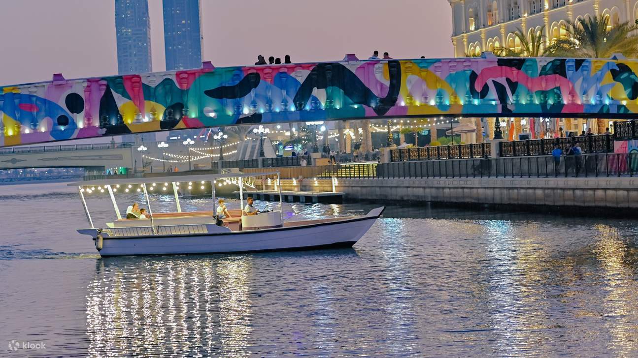 A vibrant abra boat ready to take you on a journey through the serene waters of Sharjah