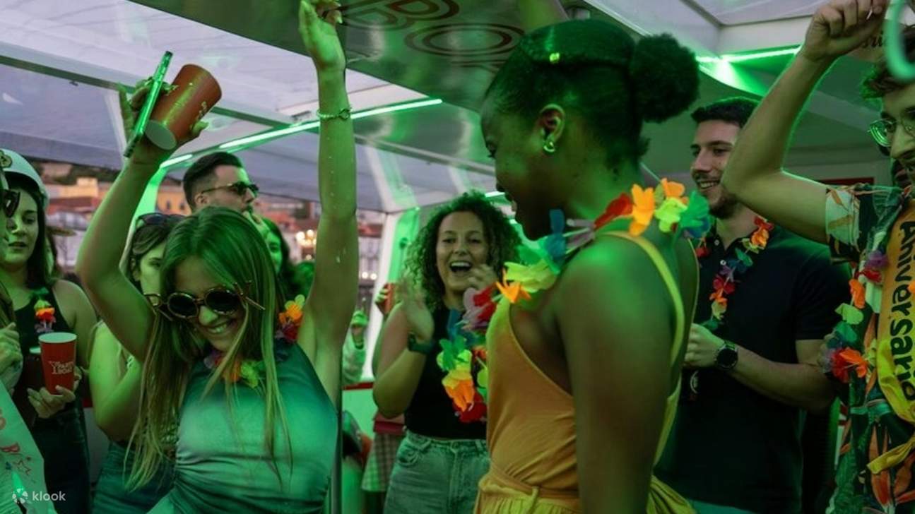 Guests dancing under dim lights, dressed in party attire, enjoying the DJ’s music