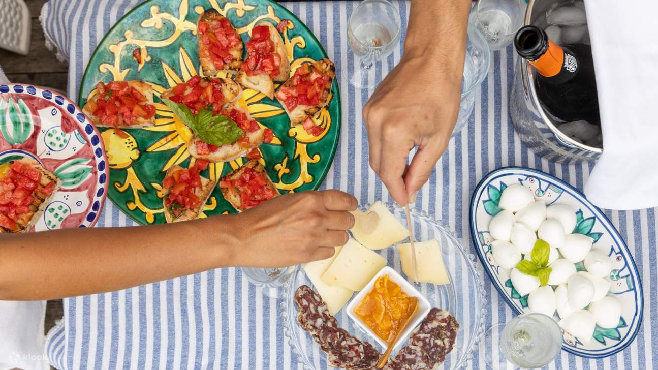 A vibrant selection of Italian aperitivo, featuring cheeses, cured meats, and refreshing drinks