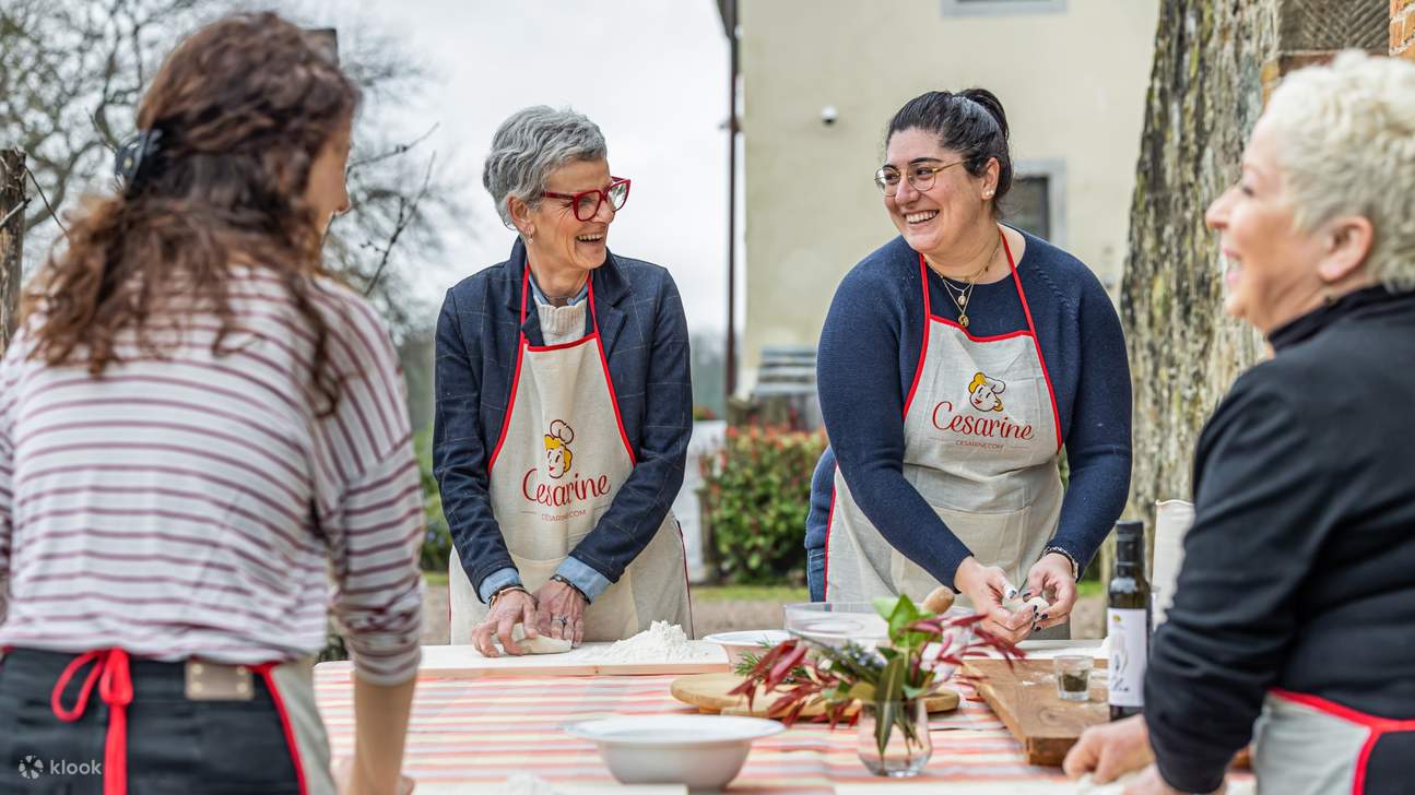 Guests smiling and having fun while learning authentic Italian cooking techniques together