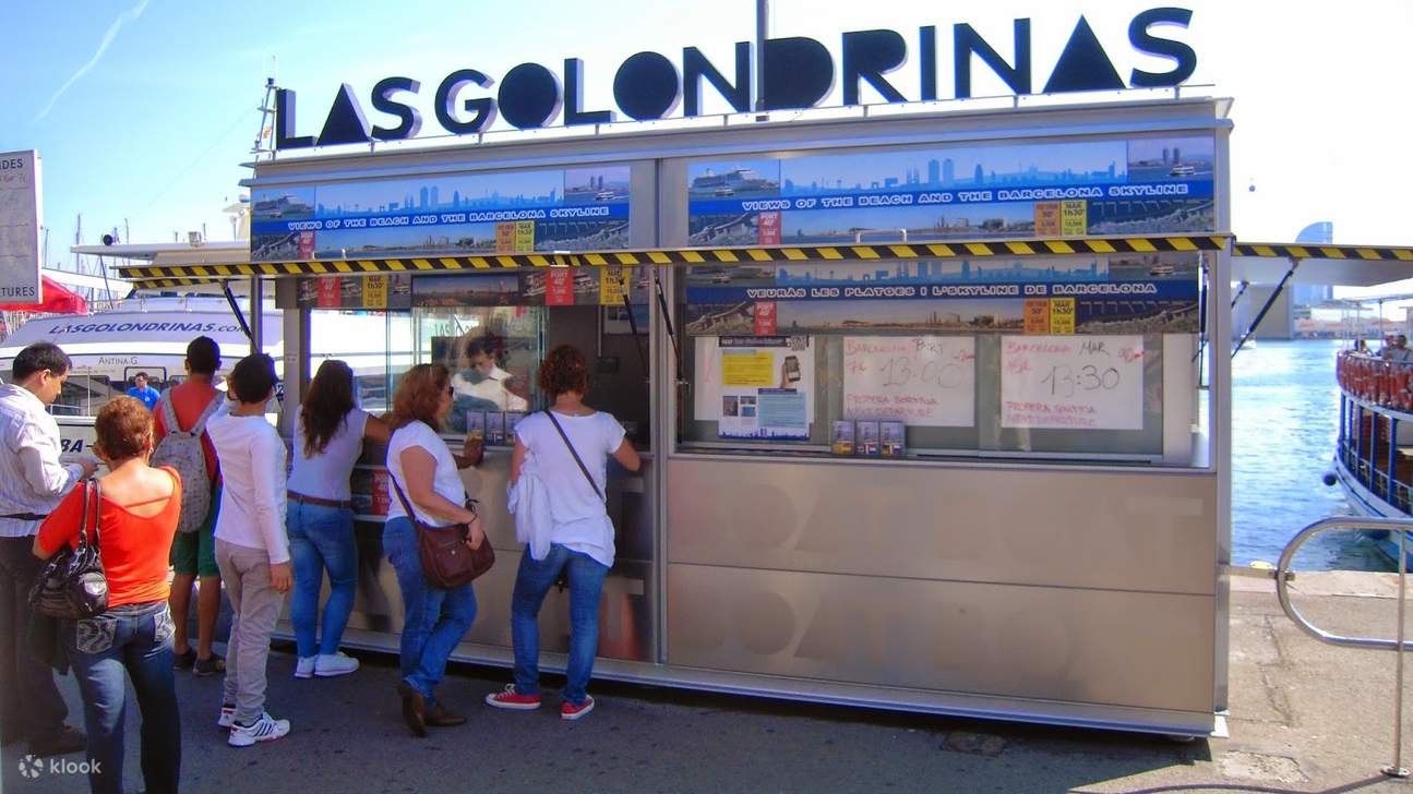 แวะไปที่บูธของ Las Golondrinas เพื่อซื้อบัตรโดยสารสำหรับการผจญภัยล่องเรือชมท่าเรือชั้นนำของ บาร์เซโลนา