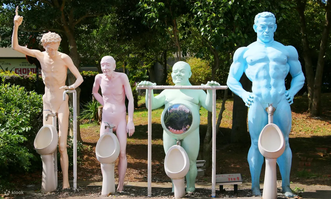sculpture of naked men with sinks that look like urinals