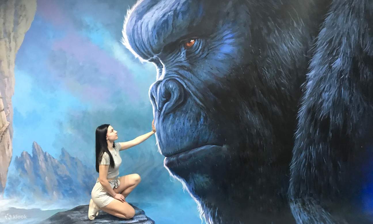 girl touching face of king kong painting