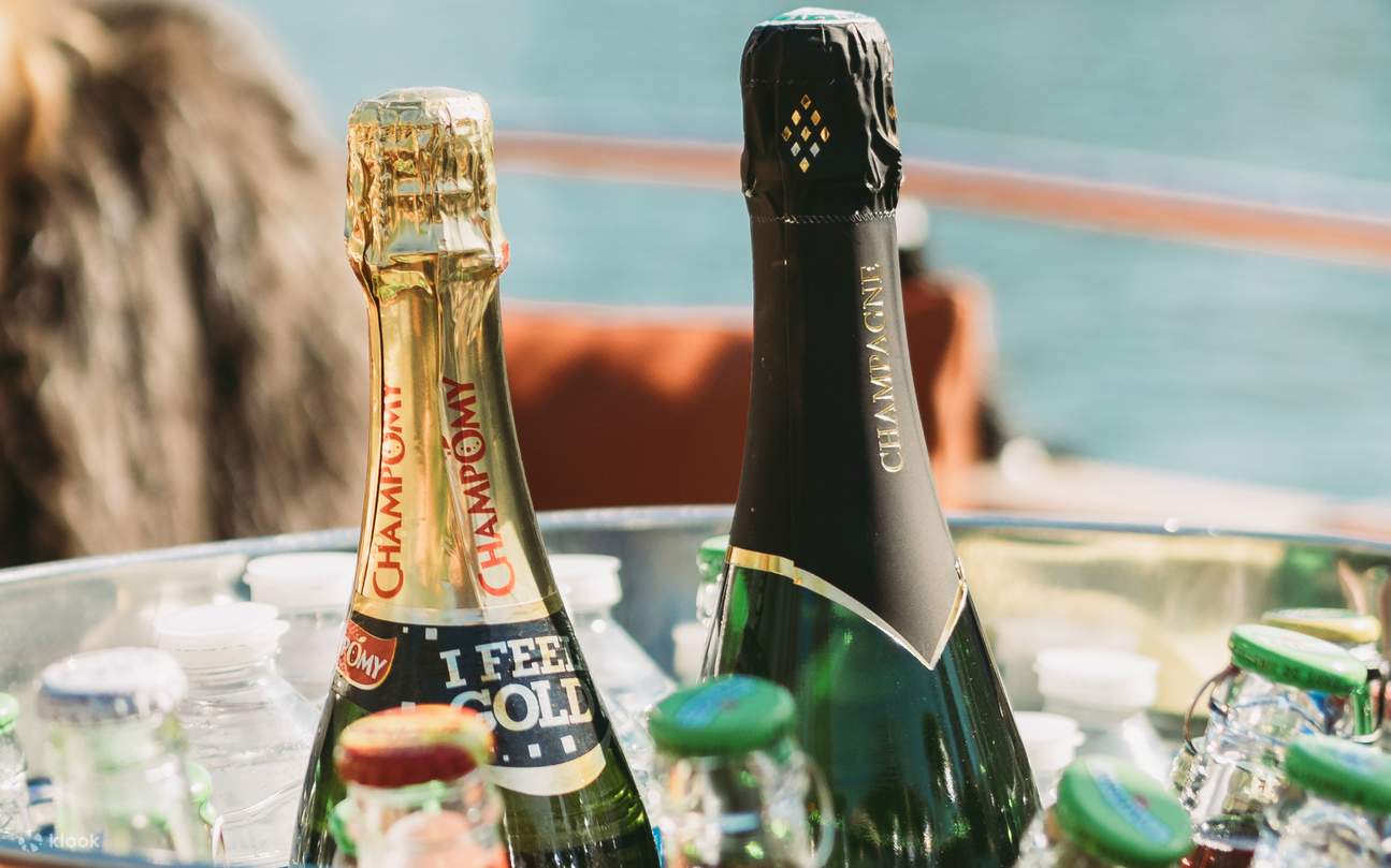 Chilled bottles of alcoholic drinks resting in an ice bucket, ready to be served
