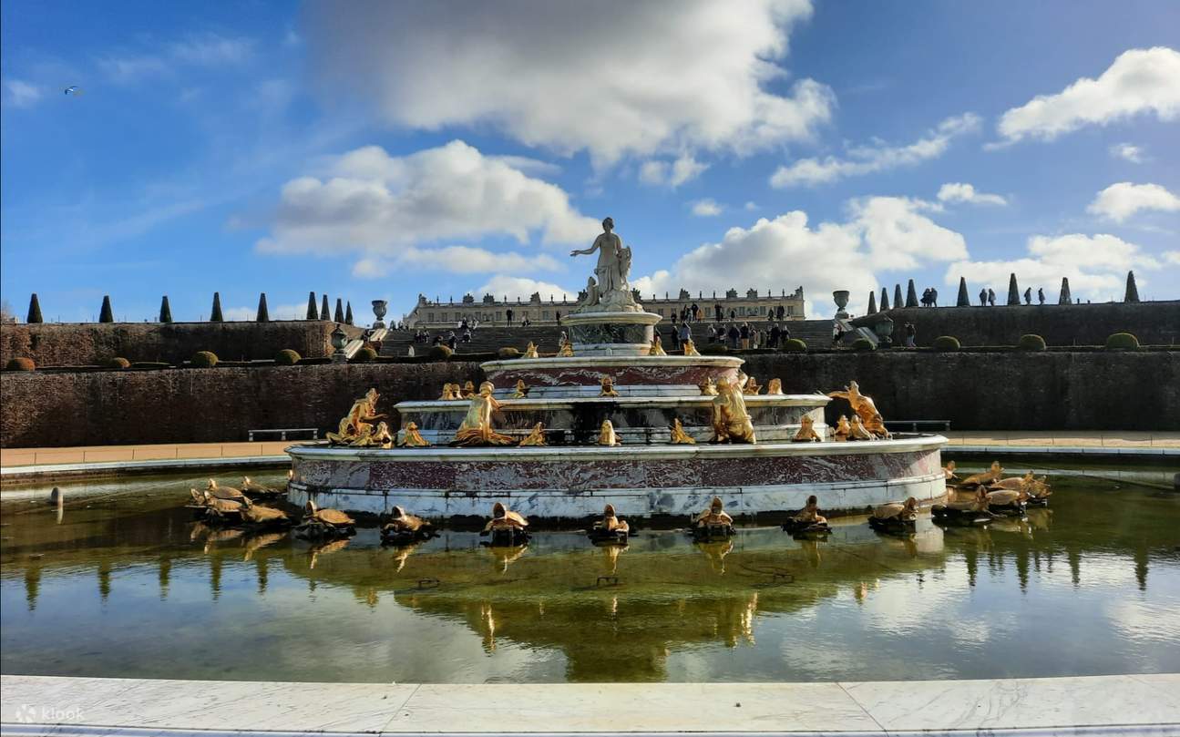 Relax in the vast Versailles Gardens surrounded by ornate fountains, sculptures, and elegant greenery