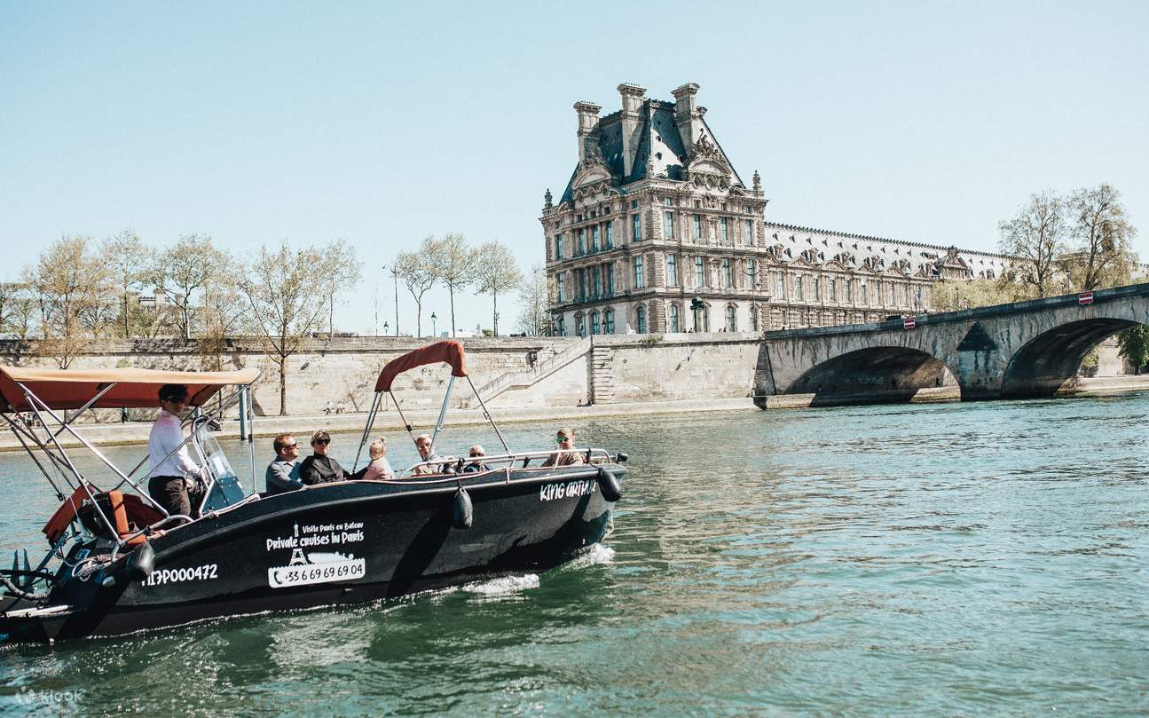 Cruising past a historic bridge on the Seine River, surrounded by stunning Parisian views