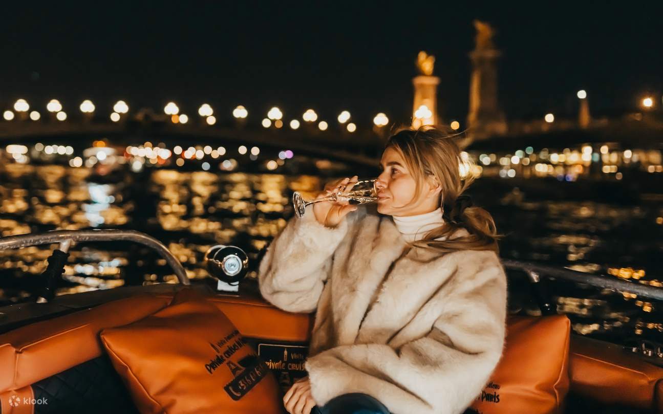 Sit back and relax with a cool drink, enjoying pretty city lights on Seine
