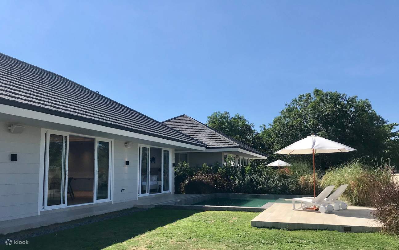 A beautiful house with a pool and a well-maintained lawn area