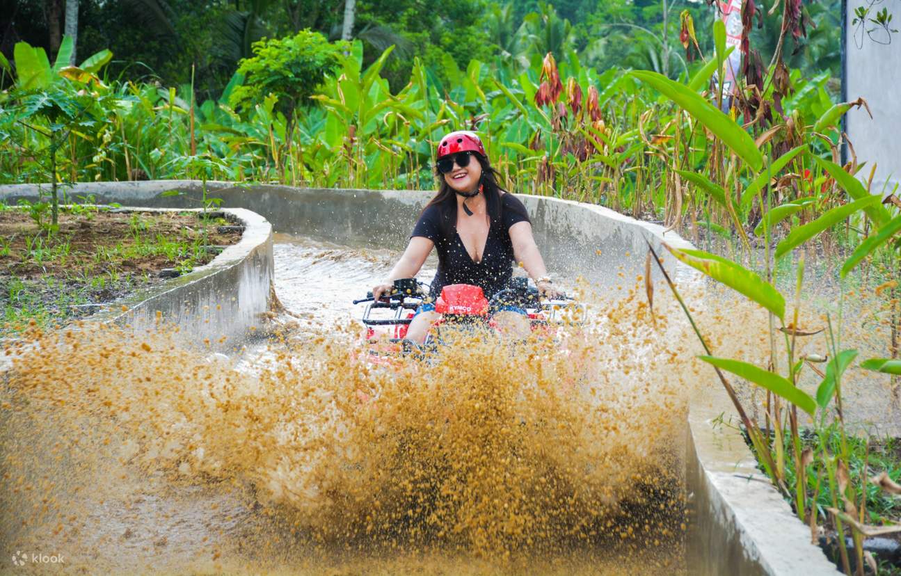 Experience riding your ATV through different terrains, such as splashing through a puddle on uneven grounds.