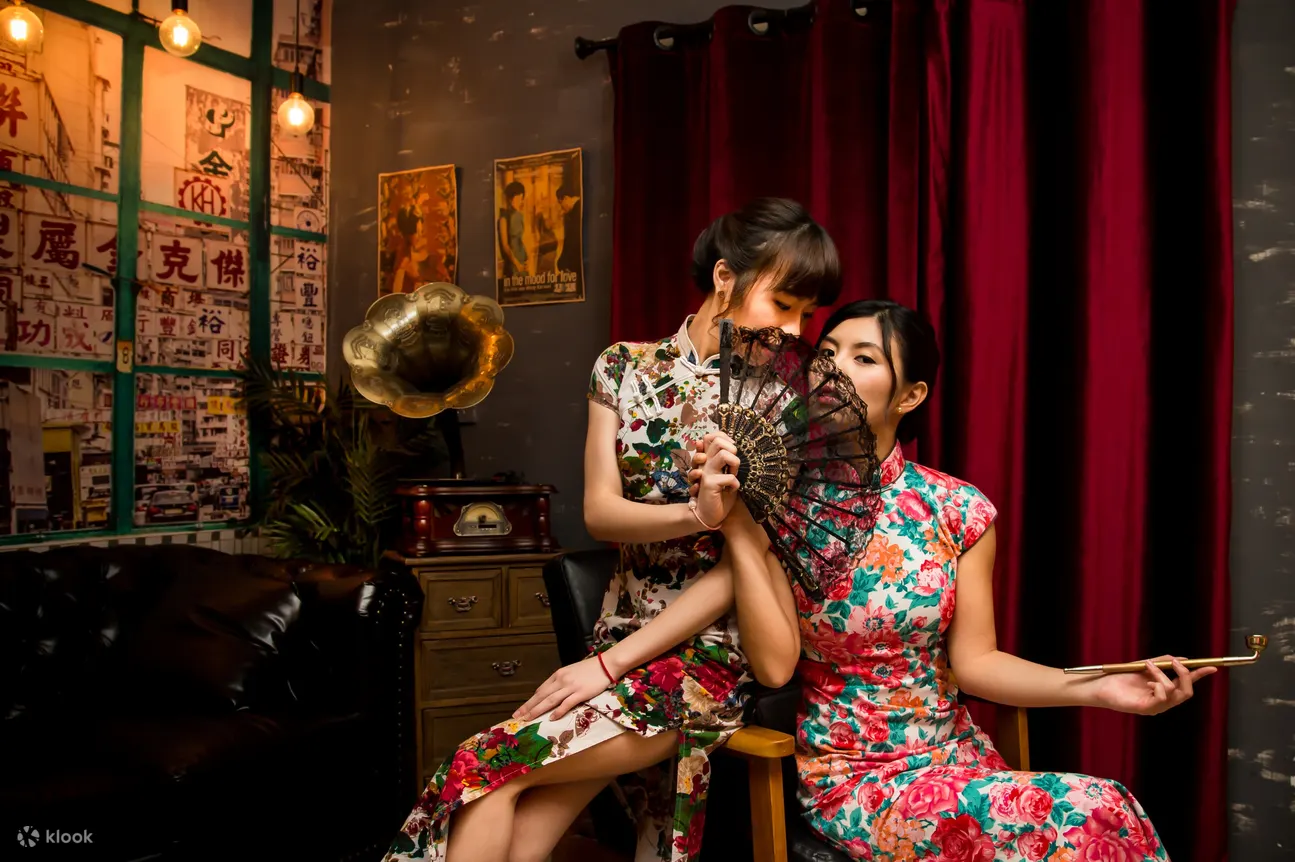 girls wearing qipao with fans and vintage background 