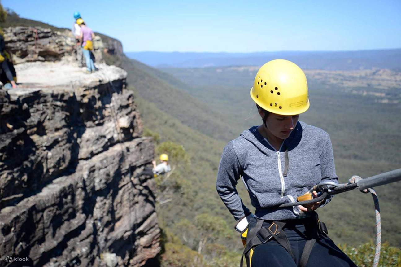 Woman about to rappel down Blue Mountains in Australia