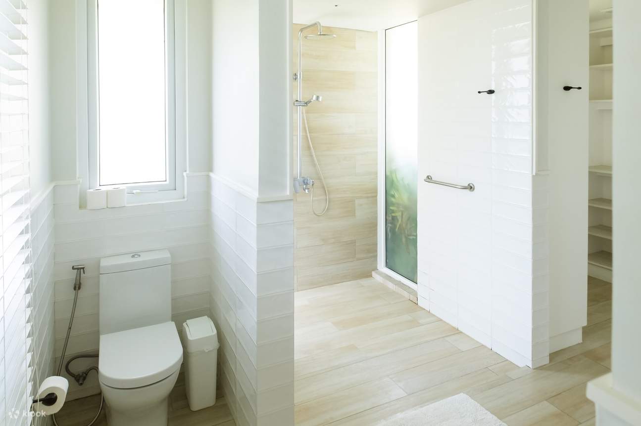 A modern bathroom with a toilet, shower, and sink