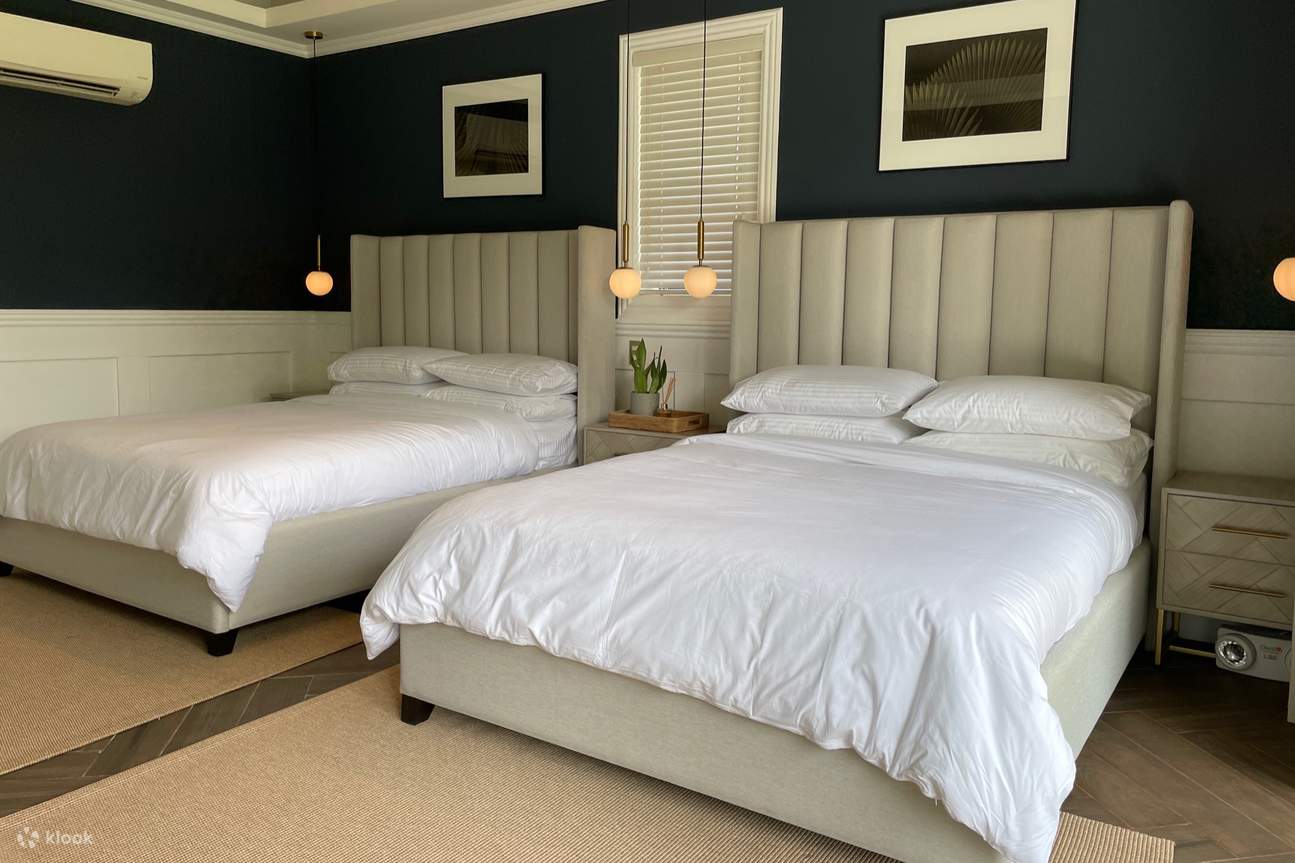 A relaxing bedroom with two beds and blue walls