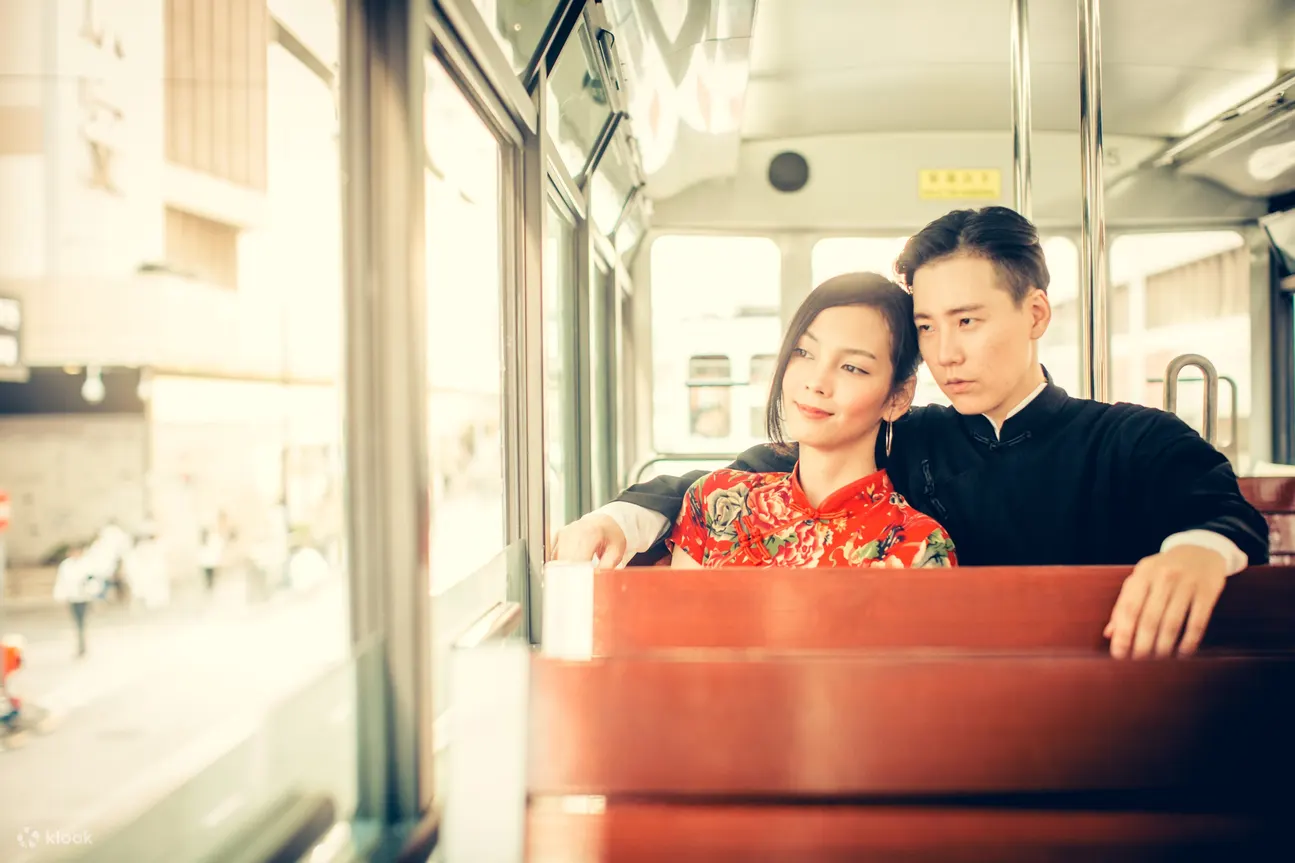 couple wearing qipao in tram 