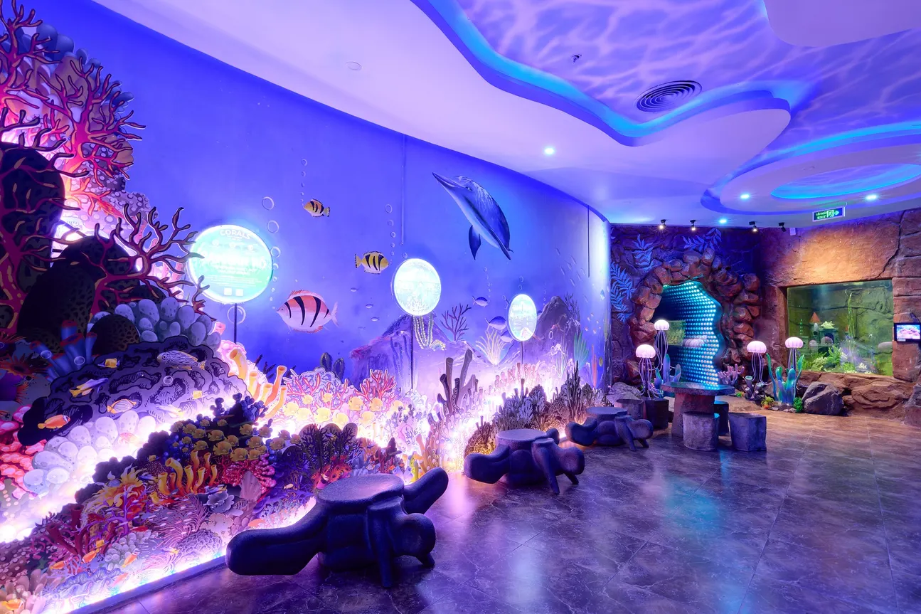 Guests can marvel at the dazzling array of vividly colored corals and the lively marine life that inhabit this meticulously recreated underwater oasis