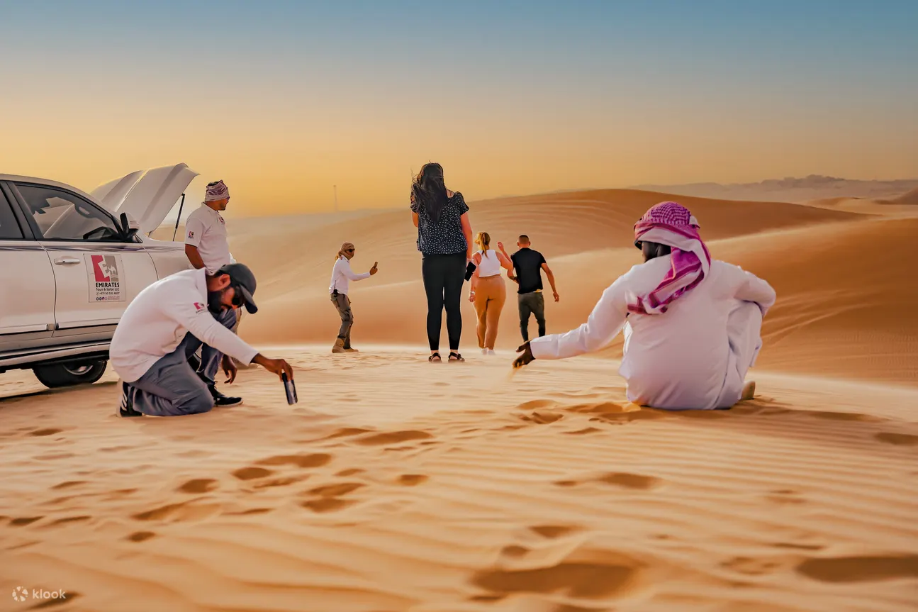 A man taking a picture in the desert dunes