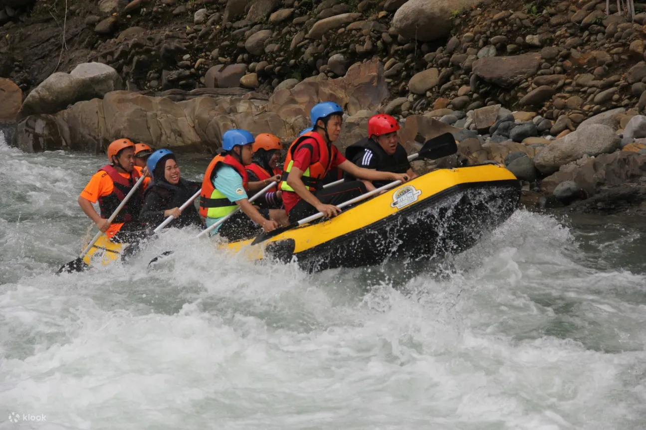 tourists try water rafting in malaysia