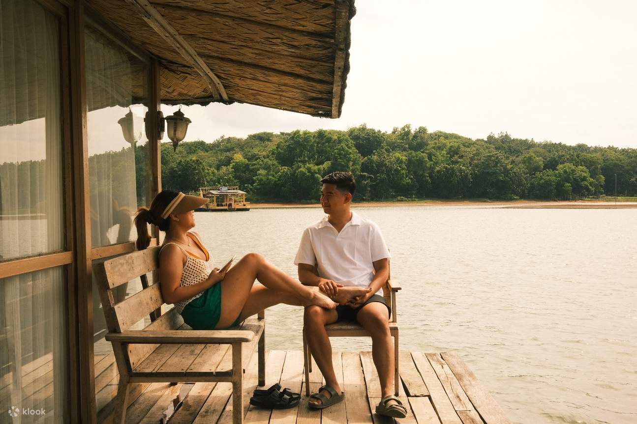 woman and man sitting on a bench on the front porch