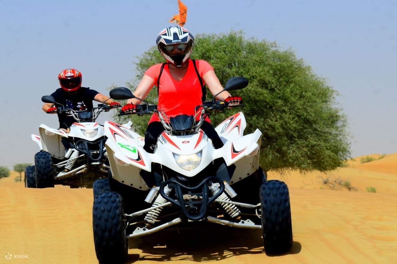 Woman in red shirt on a quad bike at Ras Al Khaimah 