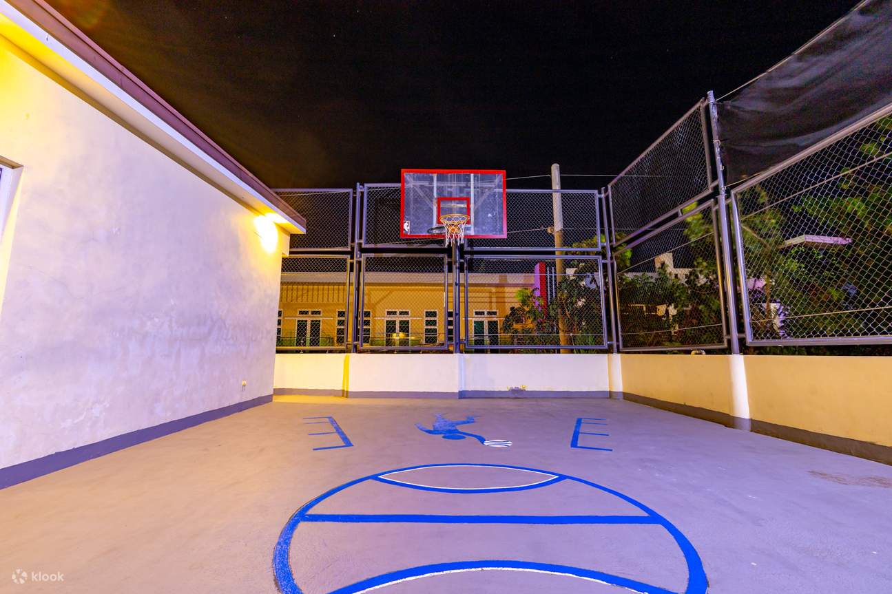 Terrain de basketball de nuit illuminé par des lumières orange