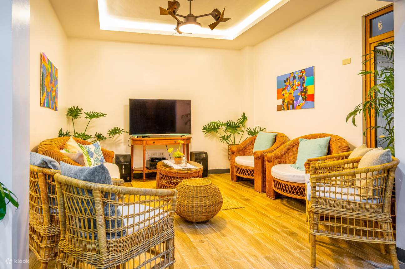 Un salon avec plusieurs fauteuils inclinables et un téléviseur