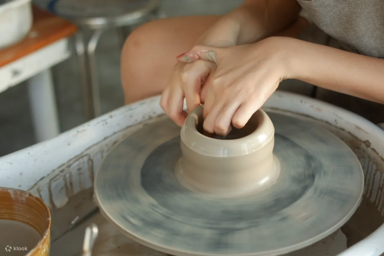 Group of people at their pottery stations enjoying their workshop