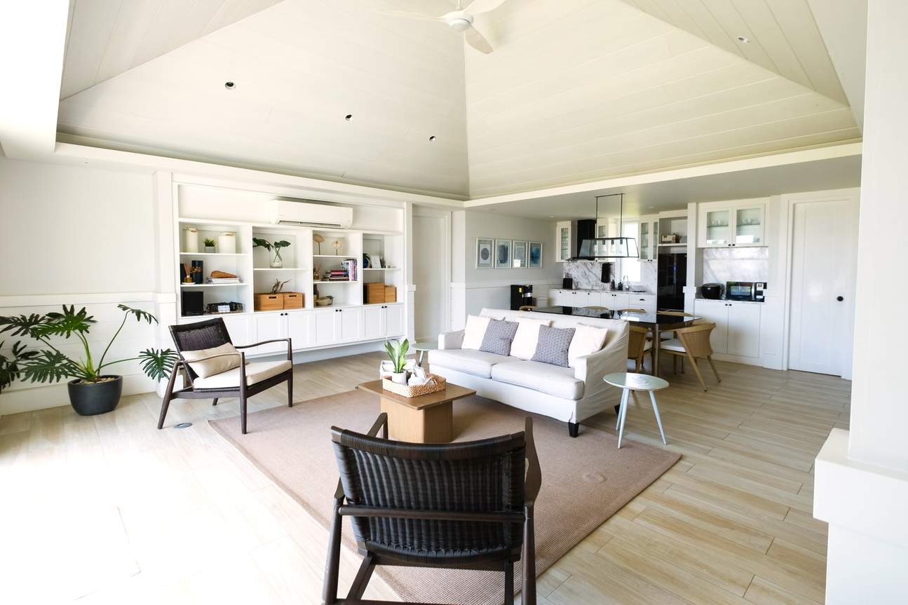 A cozy living room with a ceiling fan and a comfy couch