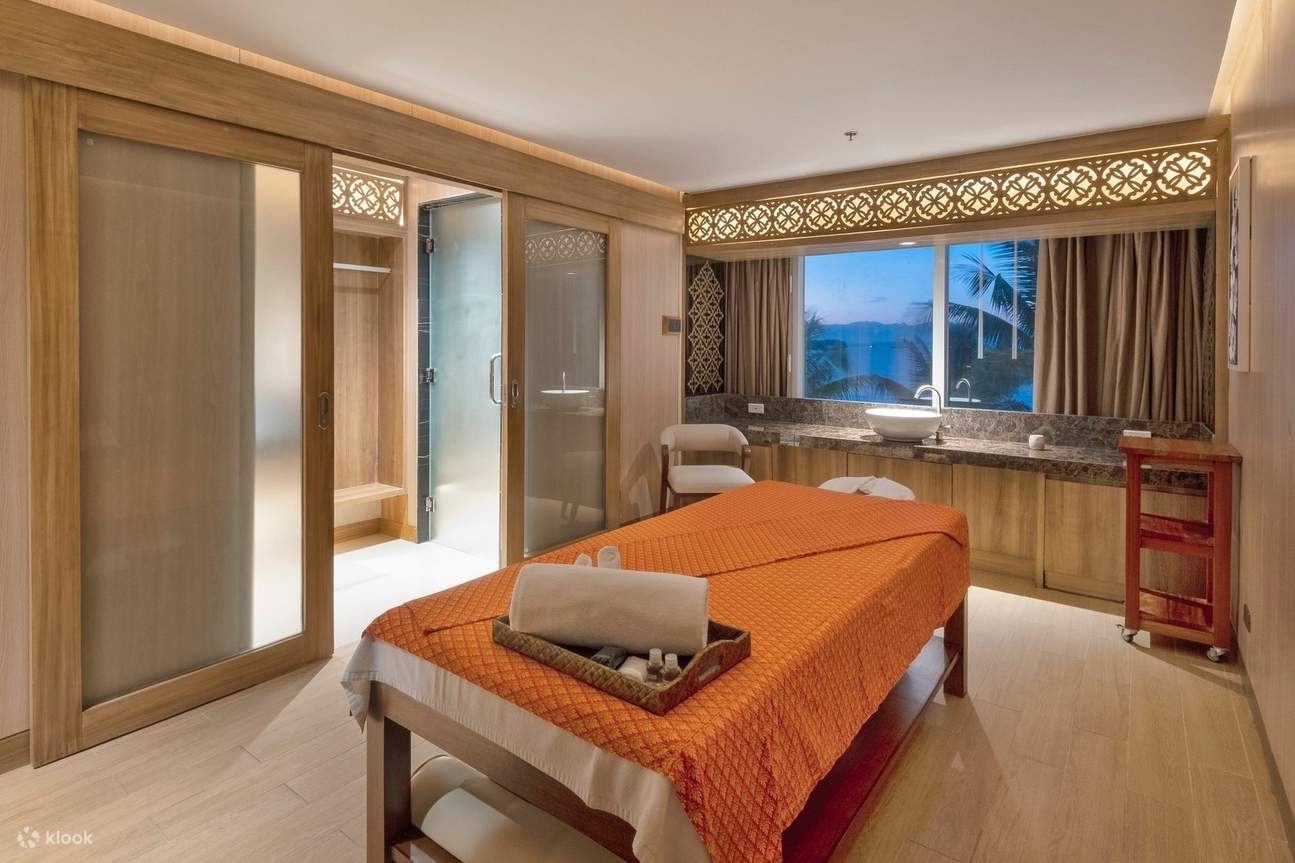 Спокойный спа-кабинет с массажным столом и видом на океан