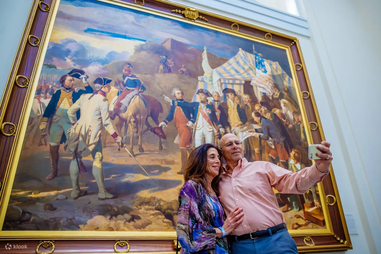 People taking a selfie in front of the Revolutionary War painting