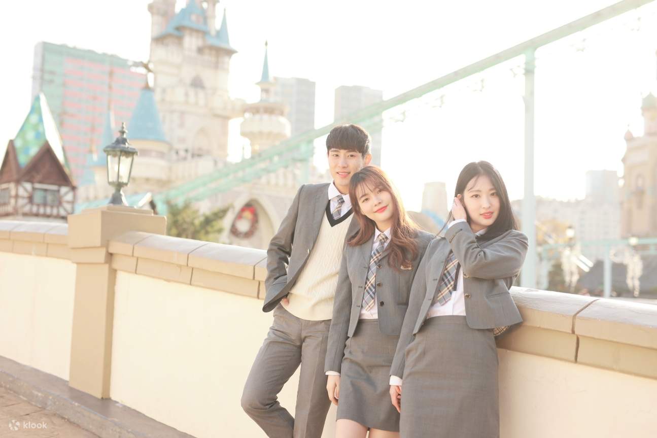 group of friends wearing korean school uniform at a theme park