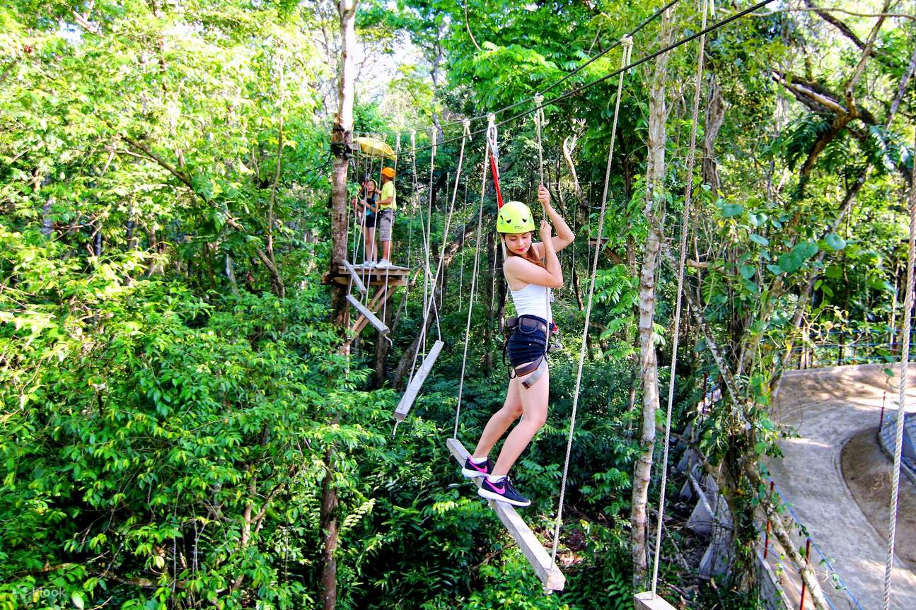 a woman holding on a rope course