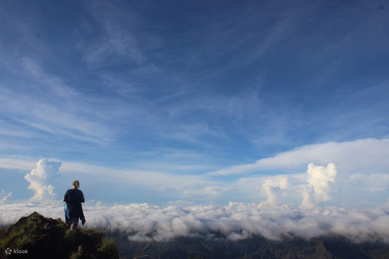 a hiker on the summit with views of fogs
