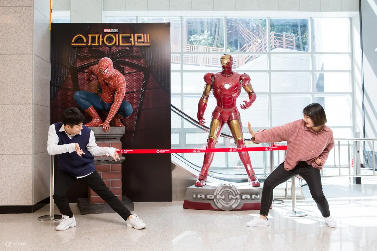 a couple posing as spiderman and iron man
