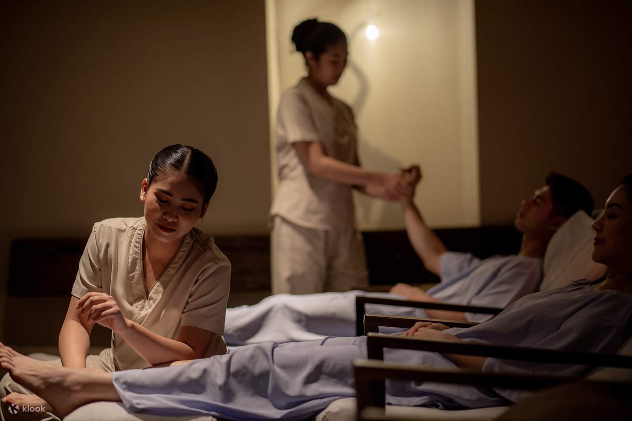 2 masajistas dando masaje a 2 clientes