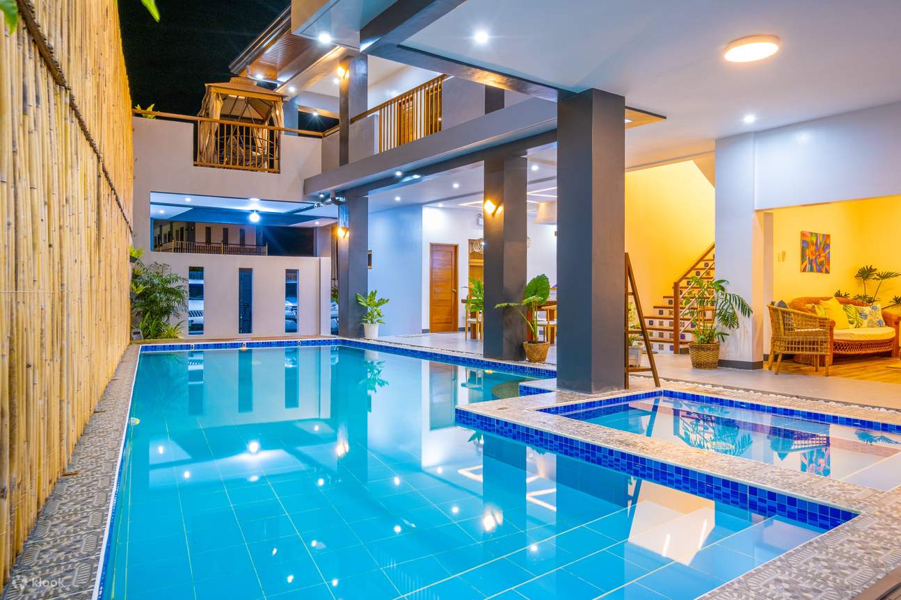 Well-illuminated indoor pool with blue tiles