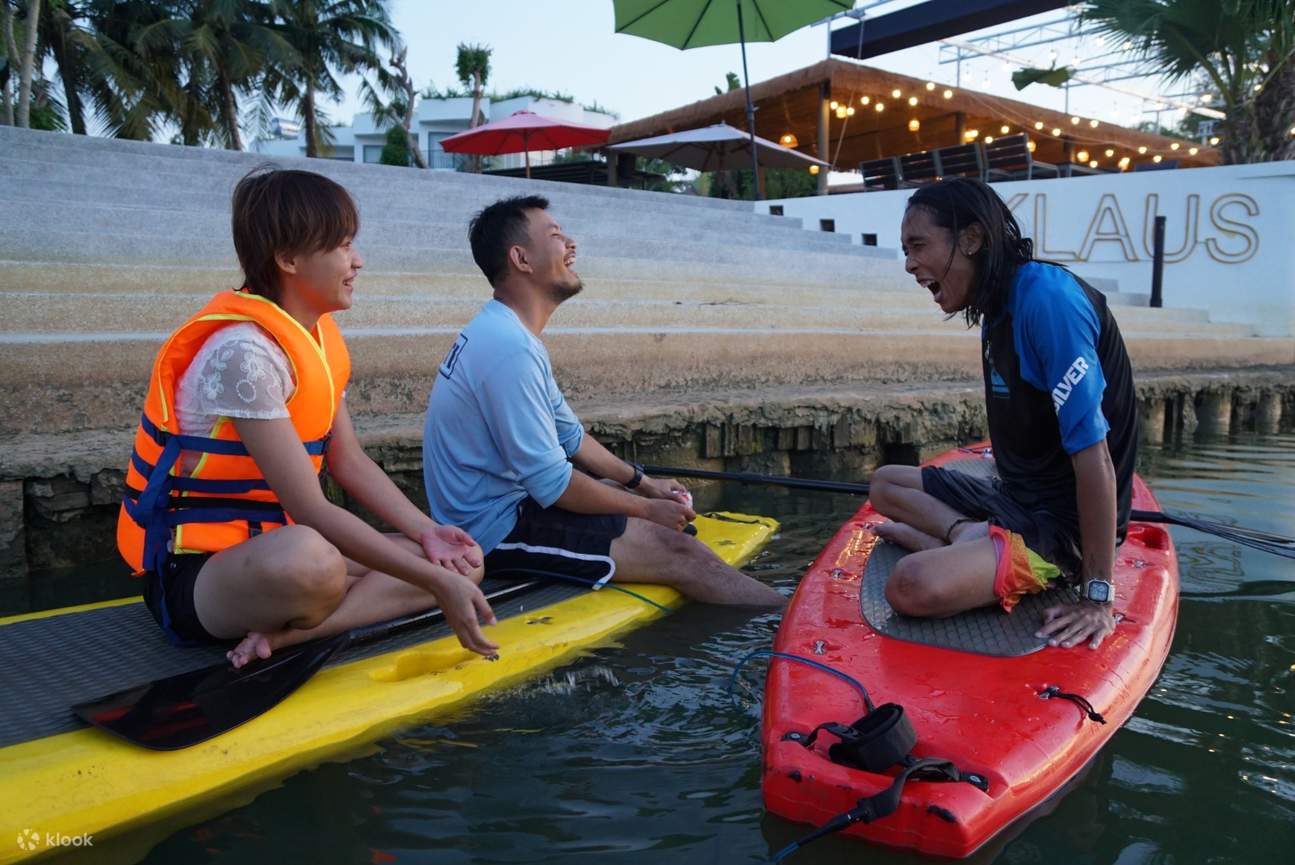 orang ramai ketawa sambil mendayung papan dayung