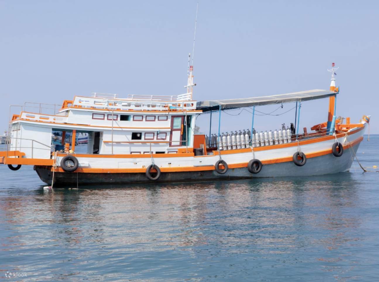 Getting ready for scuba diving on an old-school wooden boat, complete with preparation areas and full equipment.