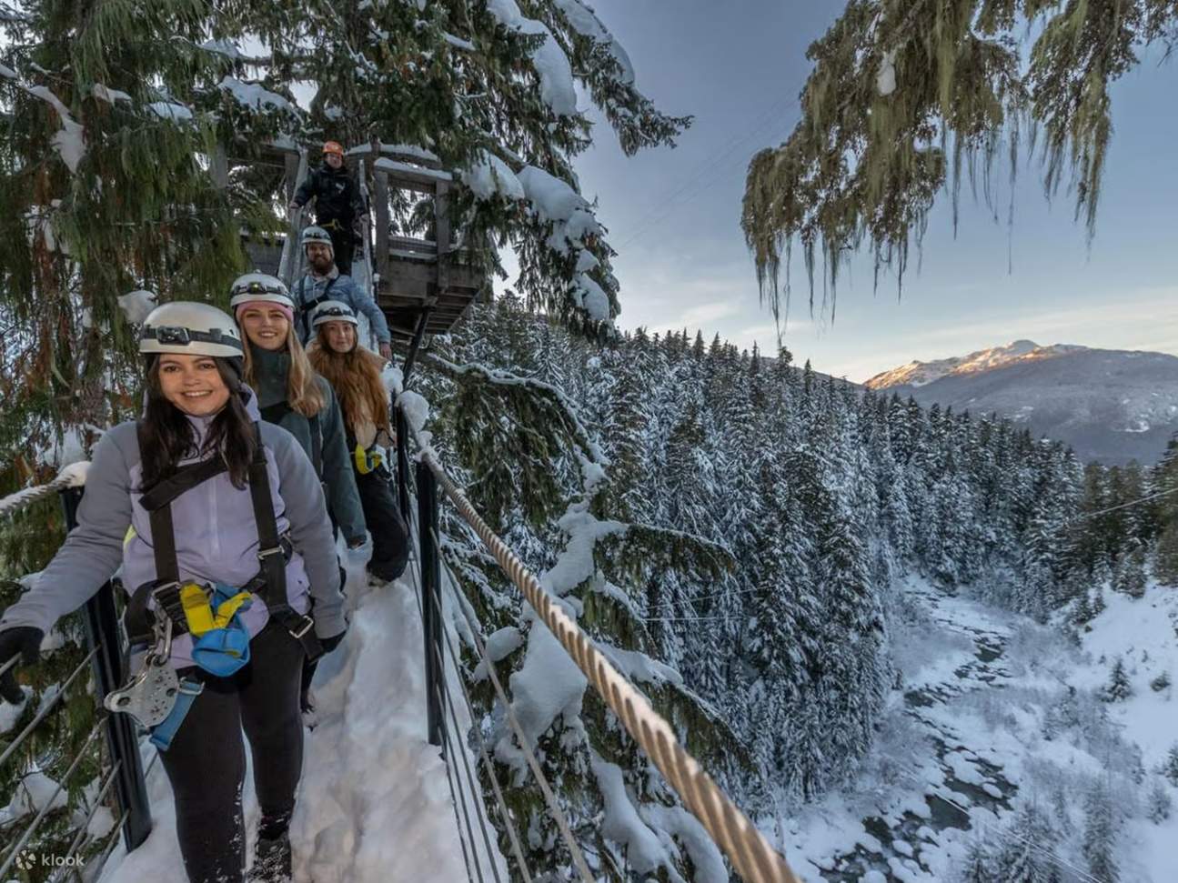Ziplining in winter offers a breathtaking view of snow-dusted treetops and mountain peaks