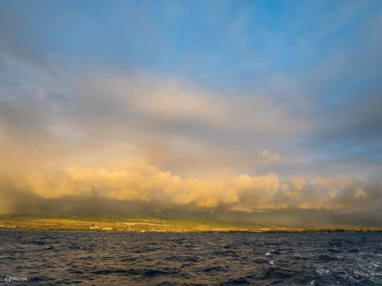Admiring sunrise where fiery orange sky meets deep blue sea