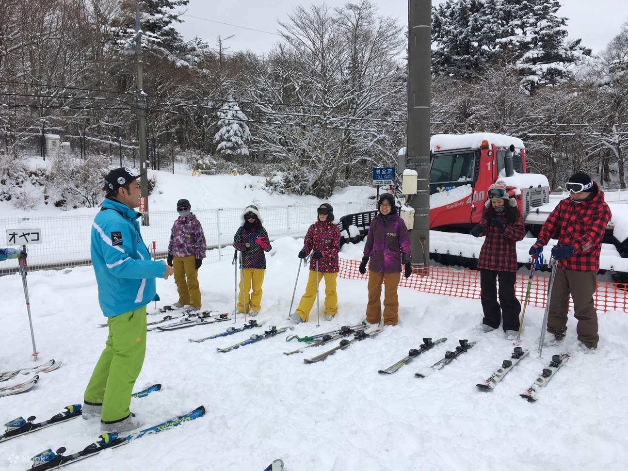 Skiers receiving tips from coach