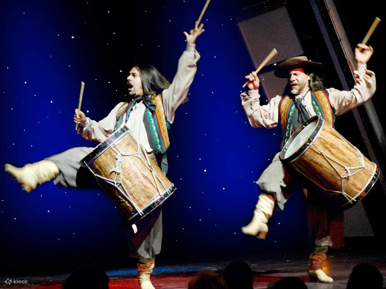 Feel the rhythm come alive as dancers drum, dance, and electrify the stage