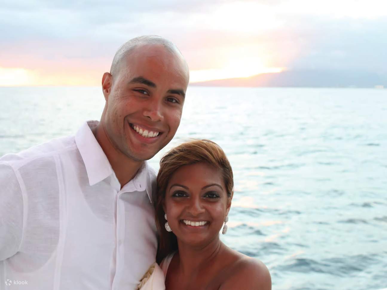 Feel romantic sea breeze wrapping the couple in serene sunset ambiance