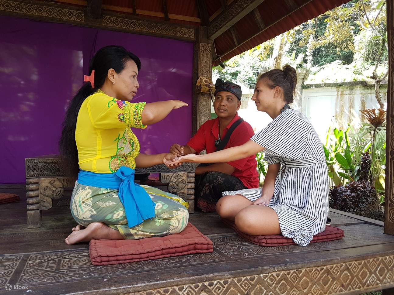 balinese healer performing palm reading