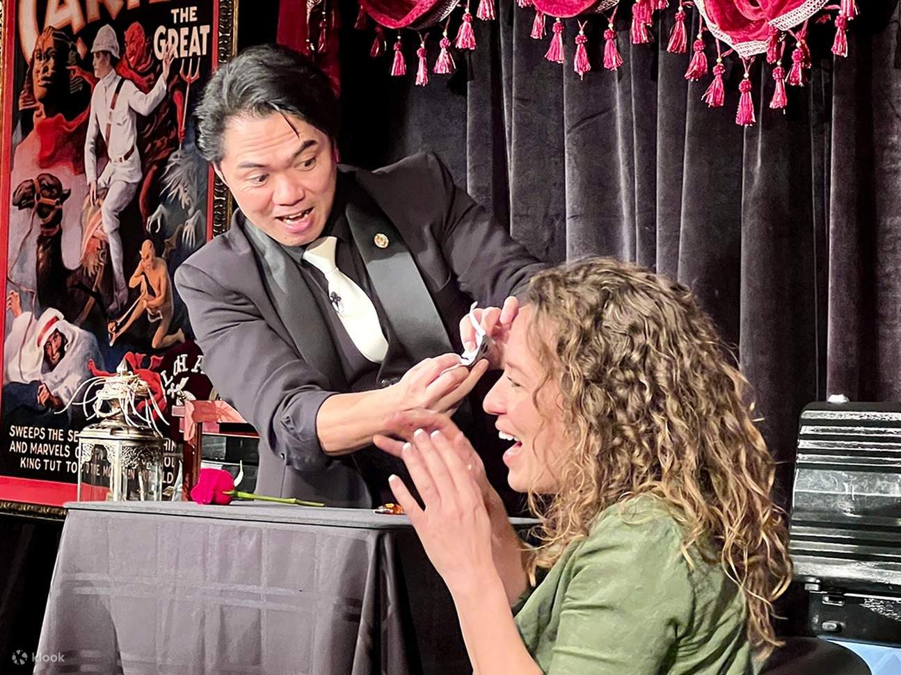 Witness the magician amaze a participant with mind-bending illusions and incredible sleight of hand