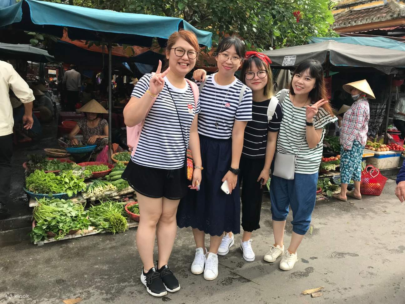 Tourists visit a local market in Hoi An