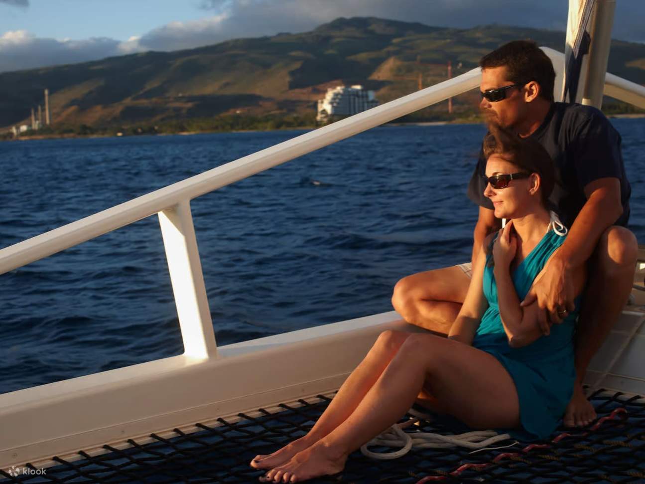 Relaxing together on deck, gazing into endless Pacific waters