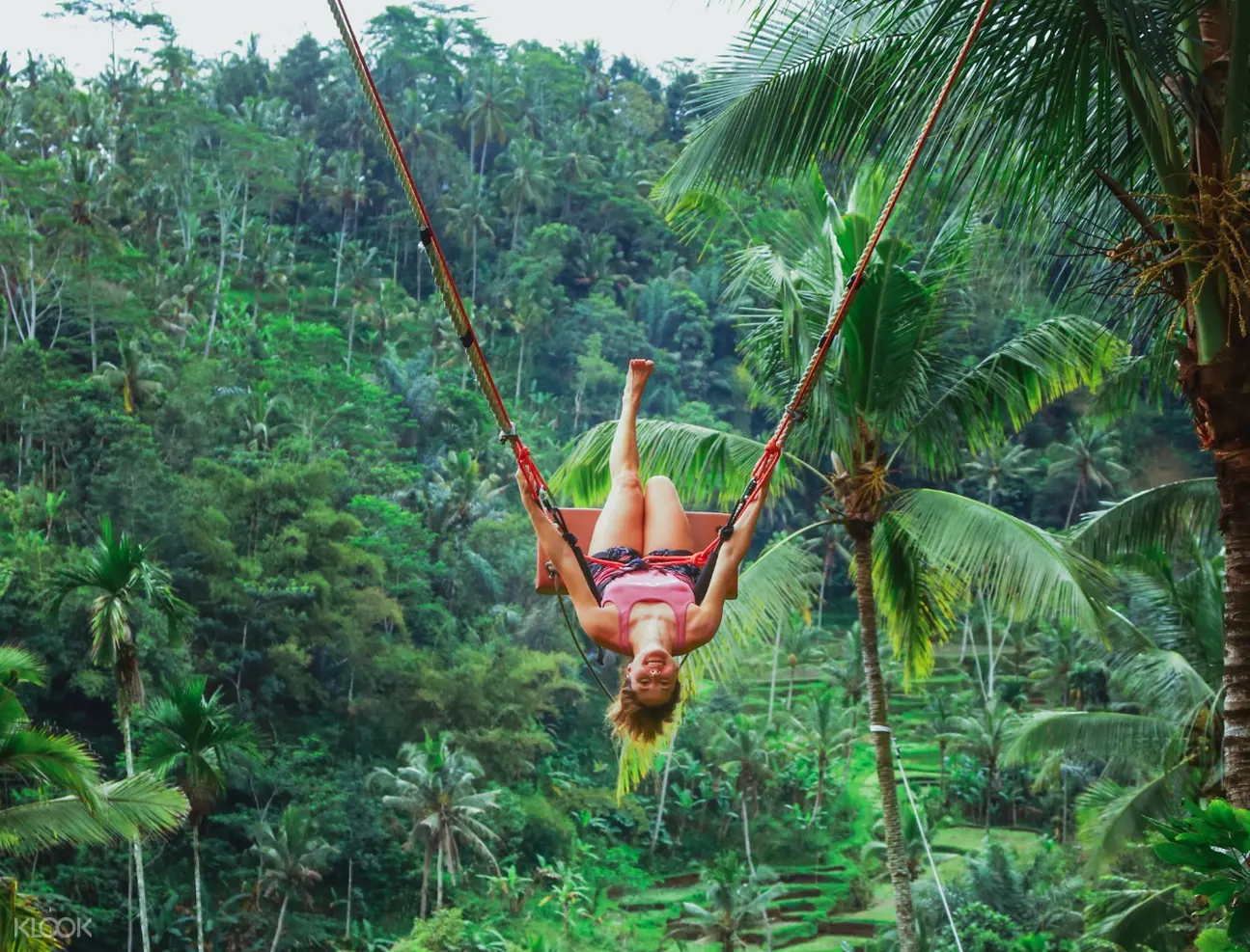 woman upside down posing on the bali jungle swing