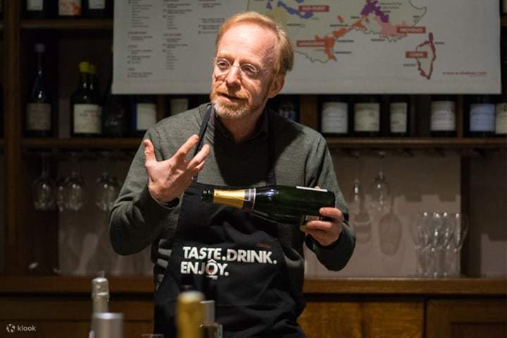 A sommelier passionately explaining a wine bottle's label